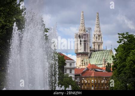 Zagreb, Croatia - 15 April, 2020 : Zagreb cathedral without both crosses on the top of the towers after earthquake that have damage it and water fount Stock Photo