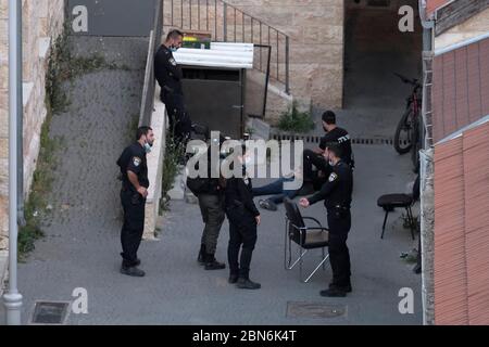 Israeli policemen detain a man inside Migrash Harusim police station in Russian Compound west Jerusalem Israel Stock Photo