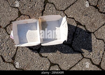 Empty box thrown away on the sidewalk Stock Photo