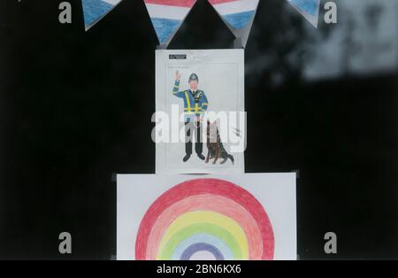 WIMBLEDON LONDON, 13 May 2020. UK. Coronavirus Lockdown.  Children's rainbow drawings  decorating a house window in Wimbledon as a show of support for the NHS (National Health Service) and all essential workers during the Coronavirus pandemic lockdown. Credit: amer ghazzal/Alamy Live News