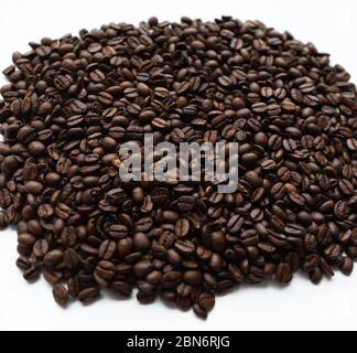 Coffee beans lying on white isolated background Stock Photo