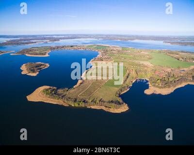 Aerial view of beautiful Kal village (former Kehlen or Kielno, East Prussia) located on Swiecajty Lake shore, Mazury, Poland