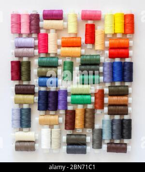 Creative arrangement of colorful threads on a white background Stock Photo