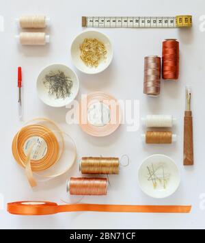 Different sewing accessories arranged neatly on a white background Stock Photo