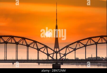 Riga, amazing sunset over Daugava river, bridge and TV tower, Latvia Stock Photo