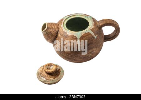 Handmade clay teapot Isolated on a white background. Antique pottery. Close-up. Stock Photo