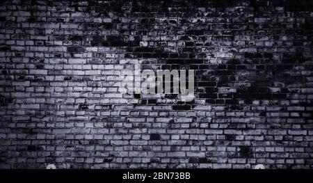 Old grunge grey brick wall in the dark Stock Photo