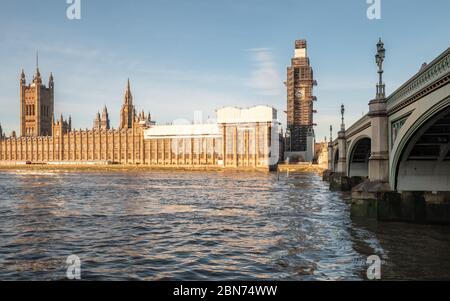 Big Ben renovation. A view over the River Thames of the  Palace of Westminster with the Big Ben clock tower covered in scaffolding. London, England. Stock Photo