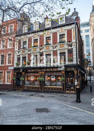 The Sherlock Holmes public house in Westminster, London. Christmas decorations are visible in the windows of this typical English pub. Stock Photo