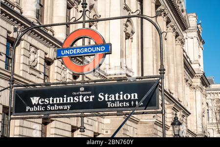 Westminster London Underground tube station roundel and sign. Close to Whitehall, the area is dominated by government offices and buildings. Stock Photo