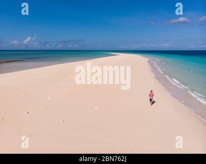 Traveller on Zanzibar. Empty beach at Snow-white sand bank of Nakupenda Island. Appearing just a few hours in a day. Aerial drone shot Stock Photo