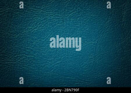 Dark navy blue leather texture background, closeup. Turquoise cracked backdrop from wrinkle skin, structure of textile with vignette. Stock Photo