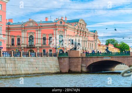 Saint Petersburg, Russia, August 4, 2019: Anichkov Bridge is the oldest bridge across the Fontanka River with The Horse Tamers sculptures and Belosselsky Belozersky Palace Neo-Baroque building Stock Photo