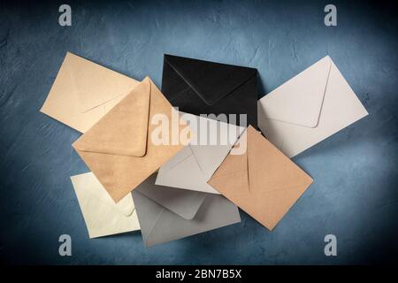 C6 envelopes, brown, gray, and black, flying in the air Stock Photo