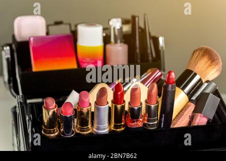 Make up case containing colorful eyeshadows, lipsticks, lip glosses, blushes and nail polishes. Stock Photo