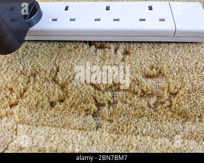 Damage caused to carpet by moths infestation Stock Photo