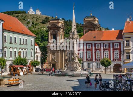 Holy Trinity Plague Column, Dietrichstein Tomb behind, St. Sebastian Chapel on the Holy Hill in distance, in Mikulov, Moravia, Czech Republic Stock Photo