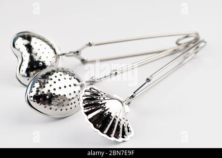 Different kinds of stainless tea strainers isolated on white background. Stock Photo