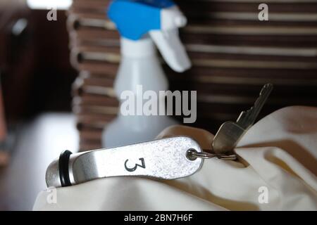 Grimma, Germany. 13th May, 2020. An employee of the Hotel Kloster Nimbschen demonstrates the cleaning of room keys before the upcoming reopening. The rules for catering businesses in Saxony will be further relaxed from 15.05.2020. Credit: Sebastian Willnow/dpa-Zentralbild/dpa/Alamy Live News Stock Photo