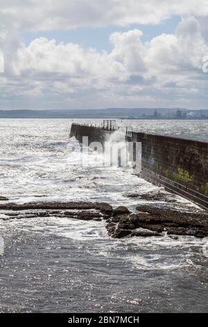 View of stormy seas at Hartlepool Headland with Industrial Teesside in background Stock Photo