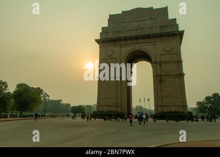 Wide shot of India Gate at sunrise with unrecognisable people Stock Photo