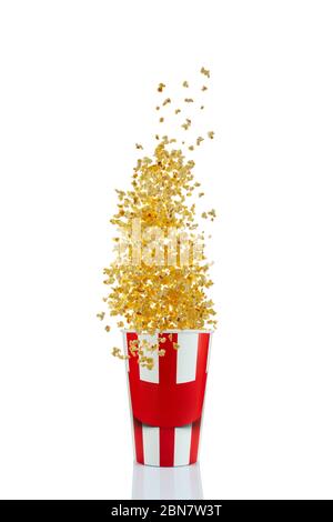 Flying popcorn from red and white paper striped bucket isolated over the white background. Cinema style popcorn Stock Photo