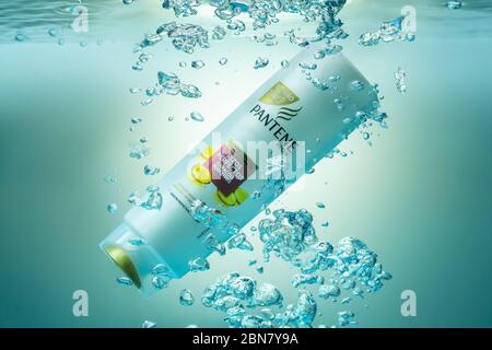 Portugal Faro, May 5, 2020 - Shampoo conditioner, from the company Panten underwater in an aquarium, with bubbles and splashes. Illustrative Editorial Stock Photo