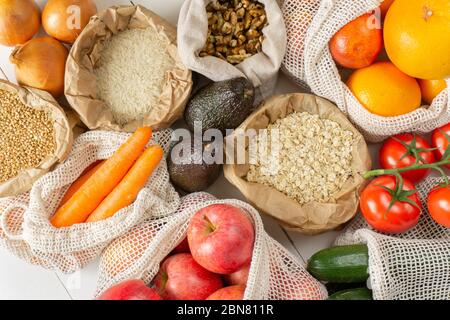 Groats, fruits, vegetables, nuts in paper and cotton bags. Top view. Zero waste, eco friendly or plastic free lifestyle concept. Stock Photo
