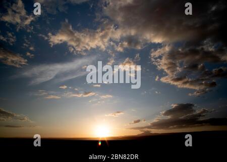 Sunset seen from the western side of Laguna Tebinquiche, San Pedro de Atacama.  Looking west towards Cerro Quimal and the Chilean Coastal Range. Stock Photo