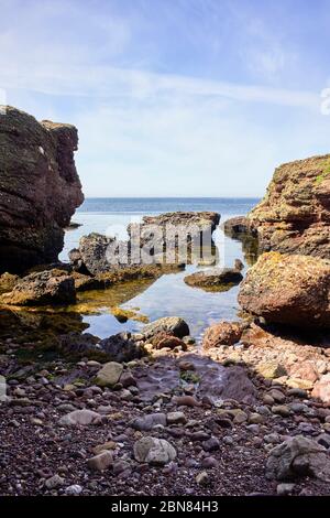 View across Castletown Bay viewed from Langness peninsular with rocks in foreground Stock Photo