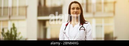 Banner of happy young female medical doctor or nurse smiling Stock Photo