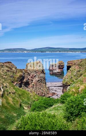 View across Castletown Bay viewed from Langness peninsular with large rocks and in foreground Stock Photo