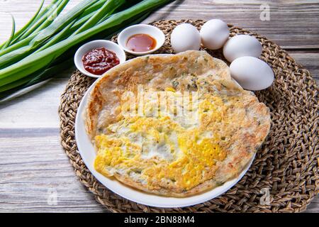 scallion pancake, is a Chinese, savory, unleavened flatbread folded with oil and minced scallions. Stock Photo