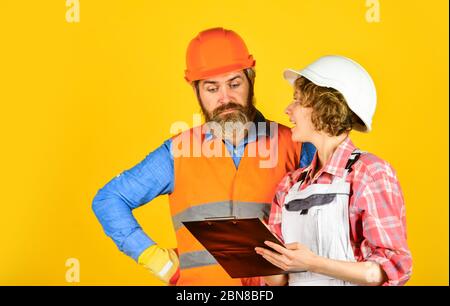 engineers couple working together on building blueprint. work at construction site or factory. Civil engineering. industrial business partner. job and occupation. confident electrical and technician. Stock Photo