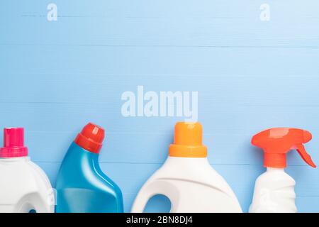 Set of detergents and cleaners in bright plastic bottles for homework and cleaning on a wooden light blue background. Copyspace. Anti Coronavirus Disi Stock Photo