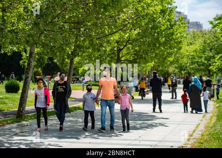 Istanbul, Turkey. 13th May, 2020. Children walk in a park near Kucukcekmece Lake in Istanbul, Turkey, May 13, 2020. Children under 14 years old in Turkey were allowed outside on Wednesday for the first time in 40 days as part of the country's COVID-19 normalization plan. Credit: Yasin Akgul/Xinhua/Alamy Live News Stock Photo