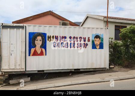 Hairdresser, improvised hair salon and barber shop in container, exterior, Imizamo Yethu Township (Mandela Park) settlement, Cape Town, South Africa Stock Photo