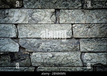 Stonework background. Pattern of stacked stone wall texture. Masonry brickwork wall with rough surface. Uneven sandstone tile. Vintage stonework wallp Stock Photo