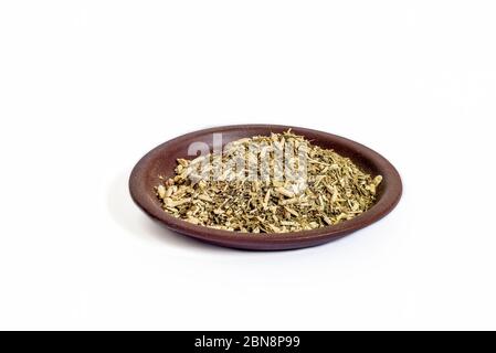 Yerba mate dry herb in clay bowl isolated on white background Stock Photo