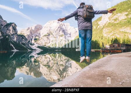 man jumping at lake beach of mountain lake Stock Photo