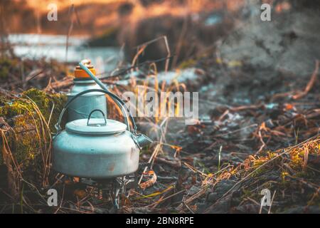 Make tea on a gas burner. Hiking with a backpack. Stock Photo