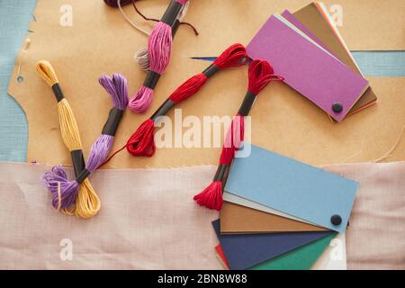 High angle view of colored patterns with threads lying on the table in workshop Stock Photo