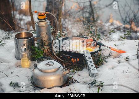 Cooking while hiking with a backpack. Stock Photo