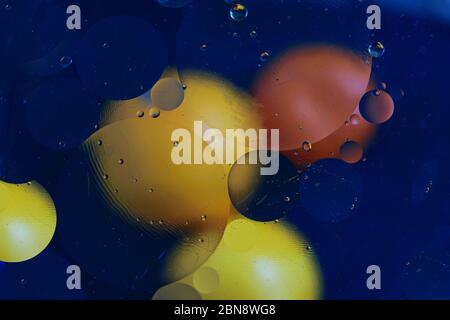 Colorful circles on the blue background, abstract texture for design. Oily drops on the water. Stock Photo
