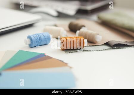 Close-up of threads with needle lying on the table and ready for hand made work Stock Photo