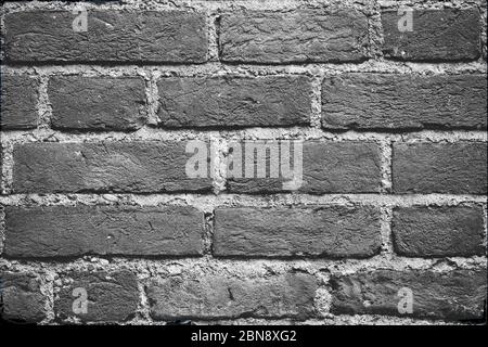 Seamless dark grey brick wall texture background. Pattern of weathered old cracked brickwall. Stacked stones wall. Home or office design backdrop. Bri Stock Photo