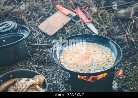 Cooking while hiking with a backpack. Stock Photo