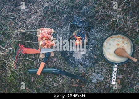 Cooking while hiking with a backpack. Stock Photo