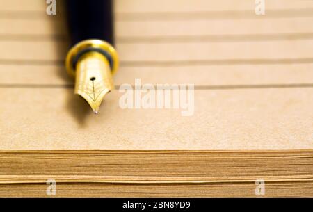 Old golden fountain pen on paper sheets, banner with copy space Stock Photo