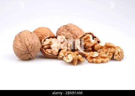 Organic Delicious whole and broken walnuts, isolated on white background Stock Photo
